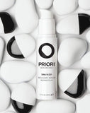 PRIORI DNA Recovery Face Serum Product amongst white and black rocks