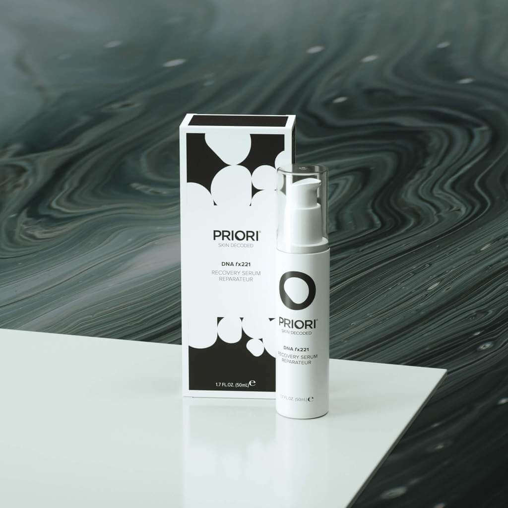 PRIORI DNA Recovery Face Serum Product and Packaging on white counter with black background 6